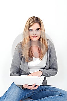 Woman working on laptop while sitting on the floor