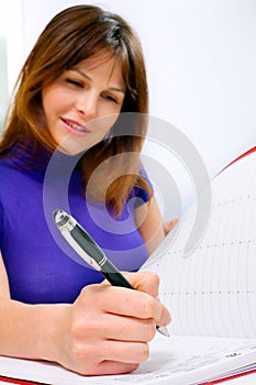 Woman working in a medical office with calendar of