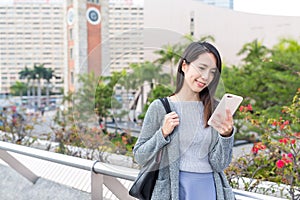 Woman working on mobile phone in Hong Kong