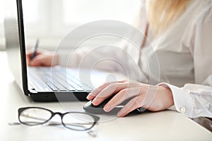 Woman working on modern computer. Laptop keyboard detail with beautiful nails hand.Quarantine, isolation and work from home during