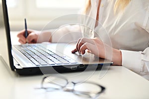 Woman working on modern computer. Laptop keyboard detail with beautiful nails hand.Quarantine, isolation and work from home during