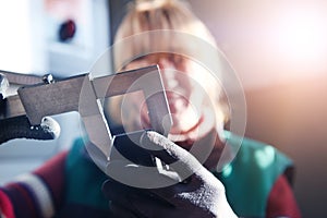 a woman working in a modern factory for the production and processing of metals, preparing and measures materials that