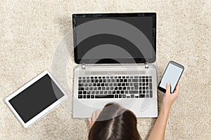 Woman working with multiple device screens