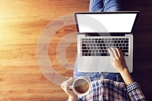 Woman working with notebook laptop computer, using finger with keyboard for typing. computer laptop with blank white screen