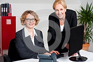 Woman working in office with colleague