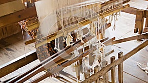 Woman working on an ordinary loom. Burma