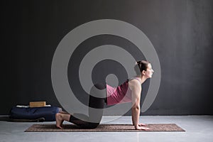 Woman working out ag doing yoga or pilates exercise. Cat, Marjaryasana