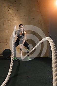 Woman working out with battle ropes