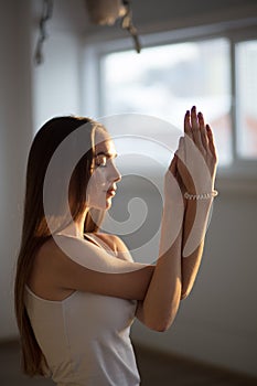 Woman working out, doing yoga exercise. Gomukasana, Cow Face pose