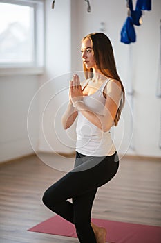 Woman working out, doing yoga exercise. Gomukasana, Cow Face pose