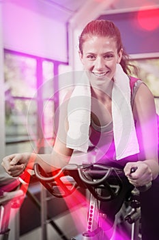 Woman working out on exercise bike at spinning class