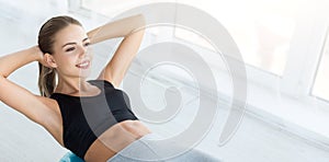 Woman working out with fitness ball in gym