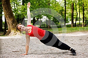 Woman working out before fitness training session in the park