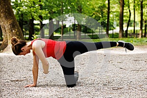 Woman working out before fitness training session in the park