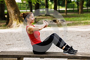 Woman working out before fitness training session in the park