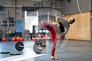 Woman working out kicking in a cross training gym