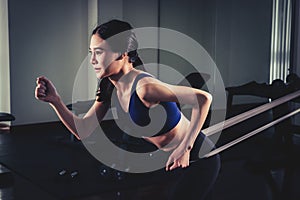 Woman working out with Resistance band in gym