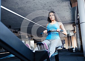 Woman working out on training simulator at gym