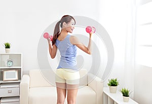 Woman working out with two dumbbells