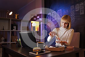 Woman working overtime eating pizza