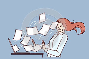 Woman working overtime is having trouble with large volume of documents or email flying out laptop