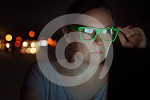 Woman working overtime on laptop computer late at night