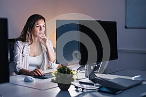 Woman working overtime in an office