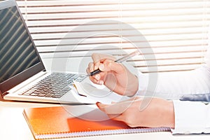 Woman working with papers and making notes