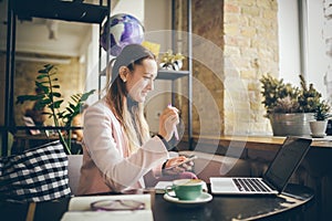 Woman working on planning project. copywriter freelancer using laptop computer, mobile phone and internet, working online,