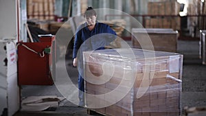 A woman working at the plant packs polyethylene refractory bricks.