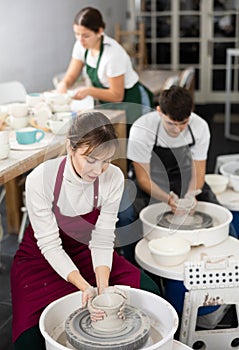 Woman working with pottery wheel