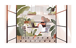 Woman working or relaxing with laptop at home balcony garden with furniture and potted plants. Modern trendy eco-style