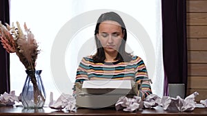 Woman Working on a Retro Typewriter at Desk