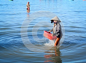 Woman working at seashore in Nhatrang