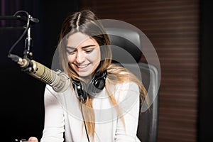 Woman working in studio as radio presenter