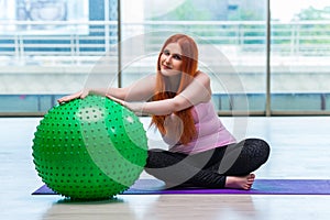 The woman working with swiss ball in the studio