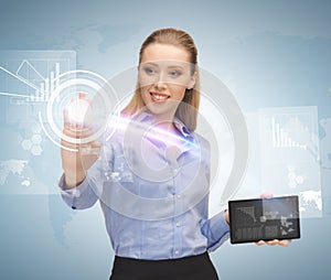 Woman working with tablet pc and virtual screen