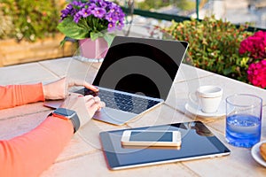 Woman working with tech gadgets outdoors photo