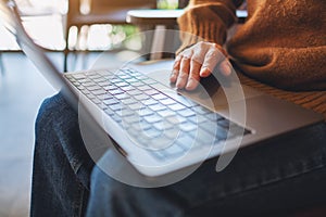 A woman working and touching on laptop computer touchpad