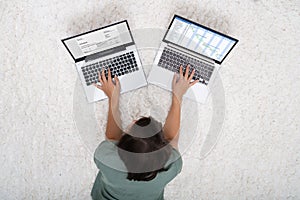 Woman Working On Two Laptops