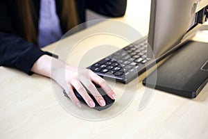 Woman working and typing on laptop computer keyboard in office