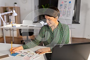 Woman working on user interface at night office