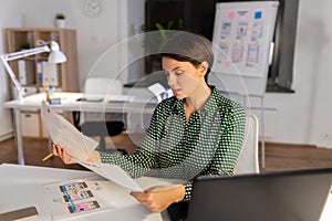 Woman working on user interface at night office