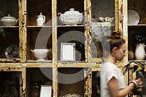 Woman working at vintage ceramics shop