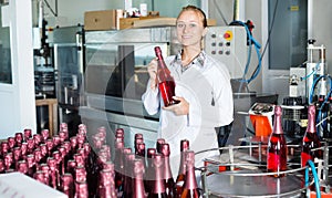 Woman working on wine production on manufactory