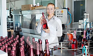 Woman working on wine production on manufactory