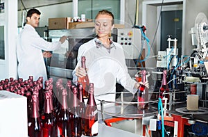 Woman working on wine production on manufactory