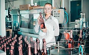 Woman working on wine production on manufactory