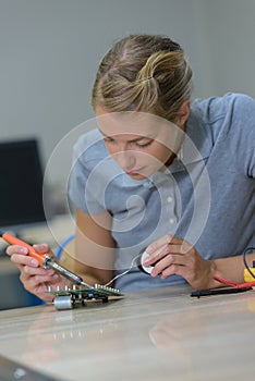 woman working with wire in workshop