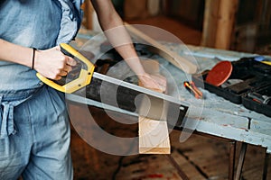 Woman working with wood in workshop. Reuse, reduce, recycle